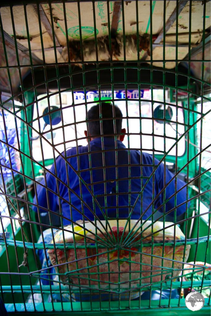 Interior view from the passenger seat of an Auto-rickshaw.