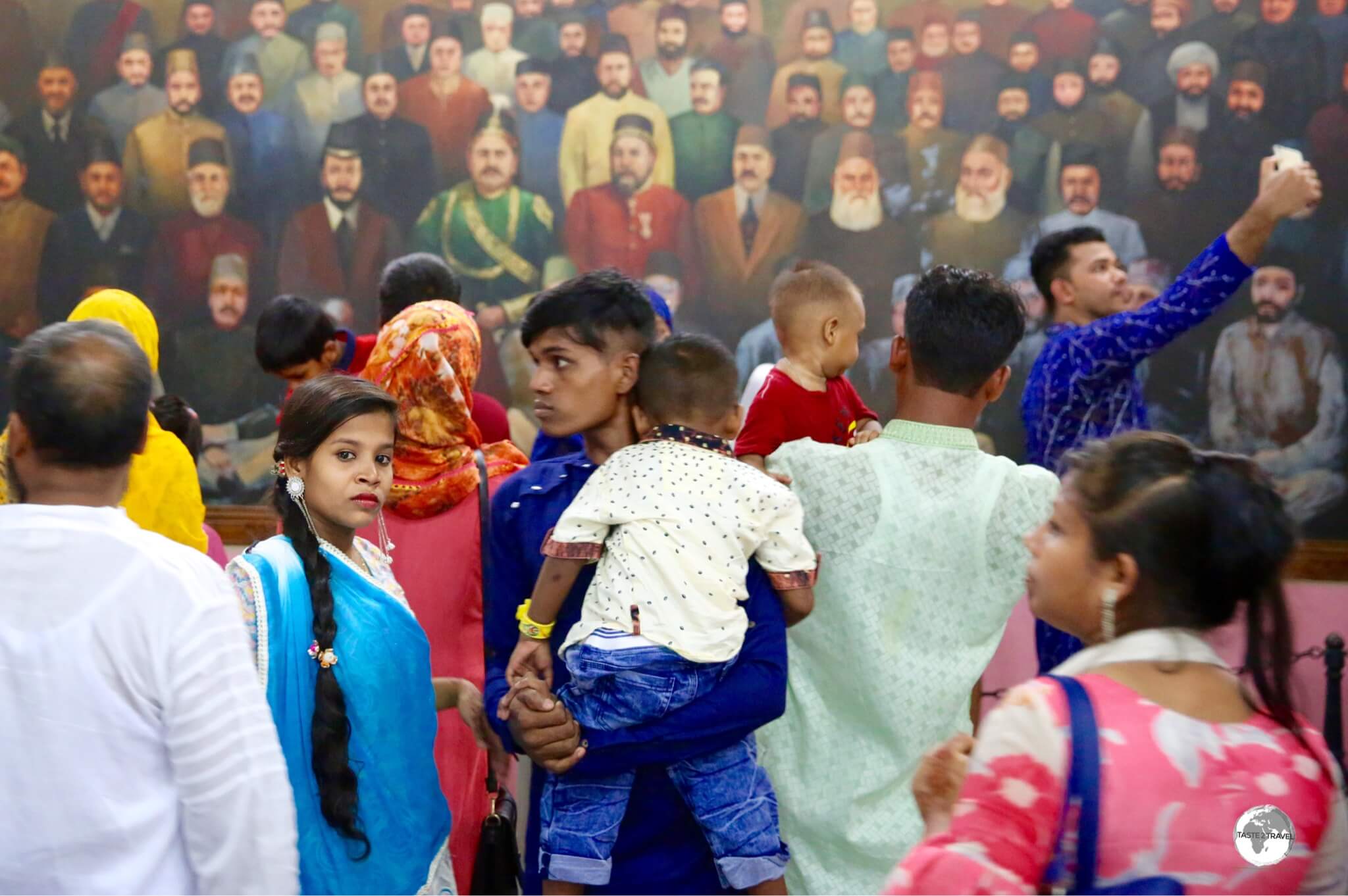 Dhaka Travel Guide: Bangladeshi visitor's observing a mural of Bangladeshi leaders inside the Pink Palace museum.