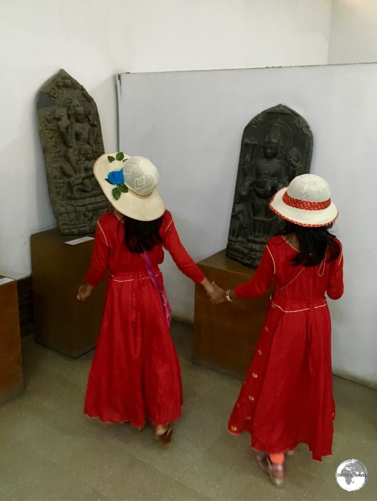 Twin sisters exploring a gallery at the Bangladesh National Museum.