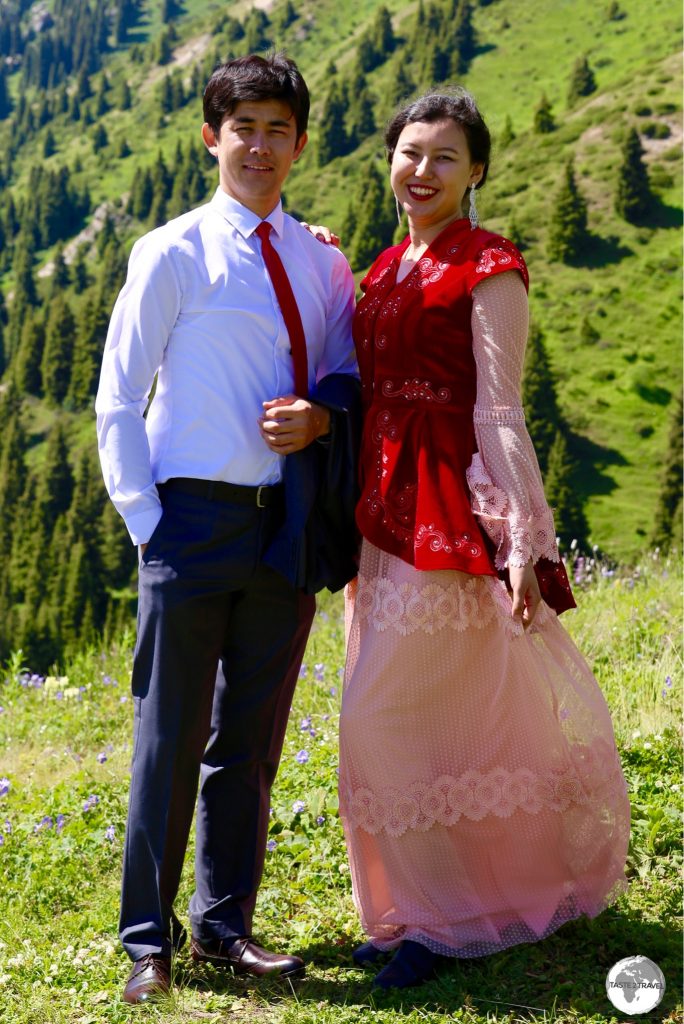 A newlywed Kazakh couple enjoying an outing on the shores of Big Almaty Lake.