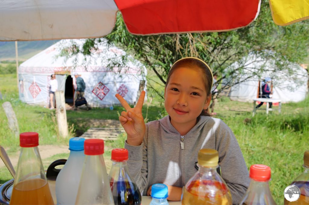 An impromptu smile and 'peace' from a charming young girl who was selling drinks at a kiosk in the Kolsoi Lakes National Park. No language needed here!