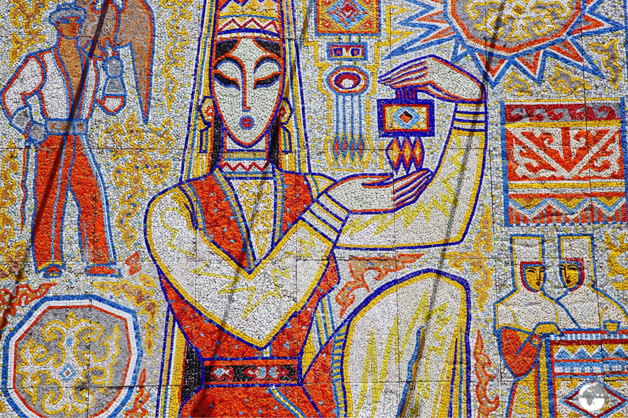 ​"The Girl with the Souvenir" is a tile mosaic which has been installed at Kok Tobe.