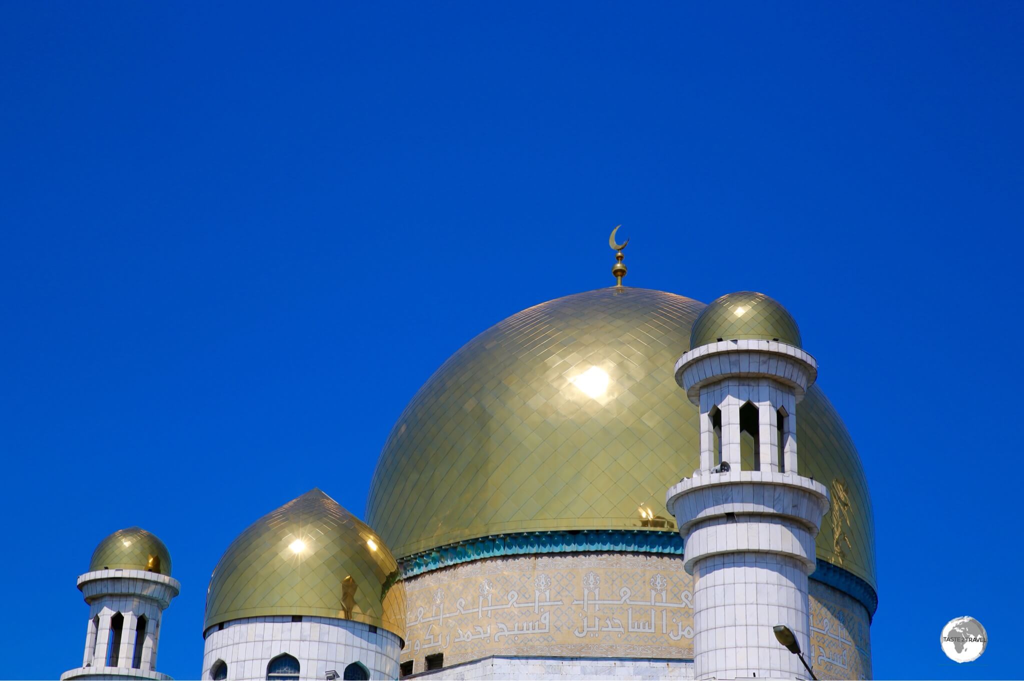 Kazakhstan Travel Guide: The large gold dome of the Almaty Central Mosque is decorated with verses from the Quran.