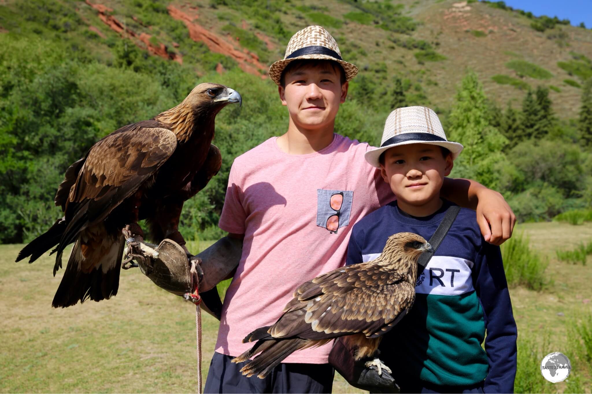 Two young eagle handlers from Jeti-Ögüz, rent their pet raptors out to tourists for the ultimate selfie photo.