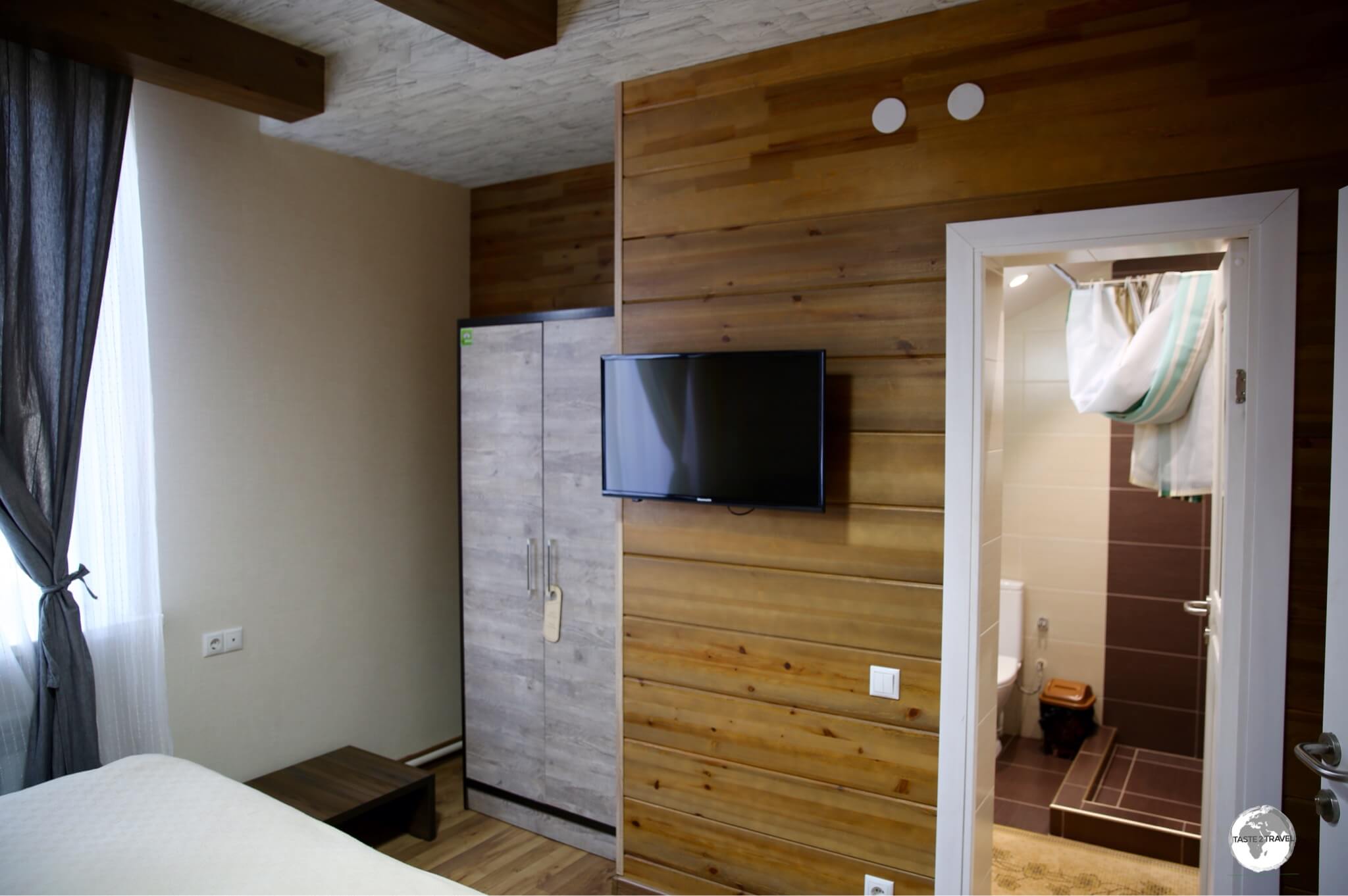 The spotlessly clean rooms at the <i>Hillside Four Seasons</i> in Karakol feature modern bathrooms, wood-panelled walls and wooden floors.