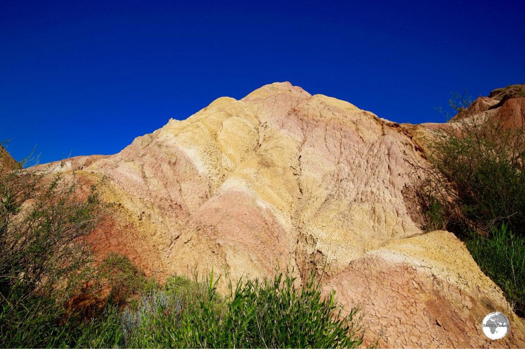 The colourful earth of the canyon contrasts brilliantly against the blue sky.