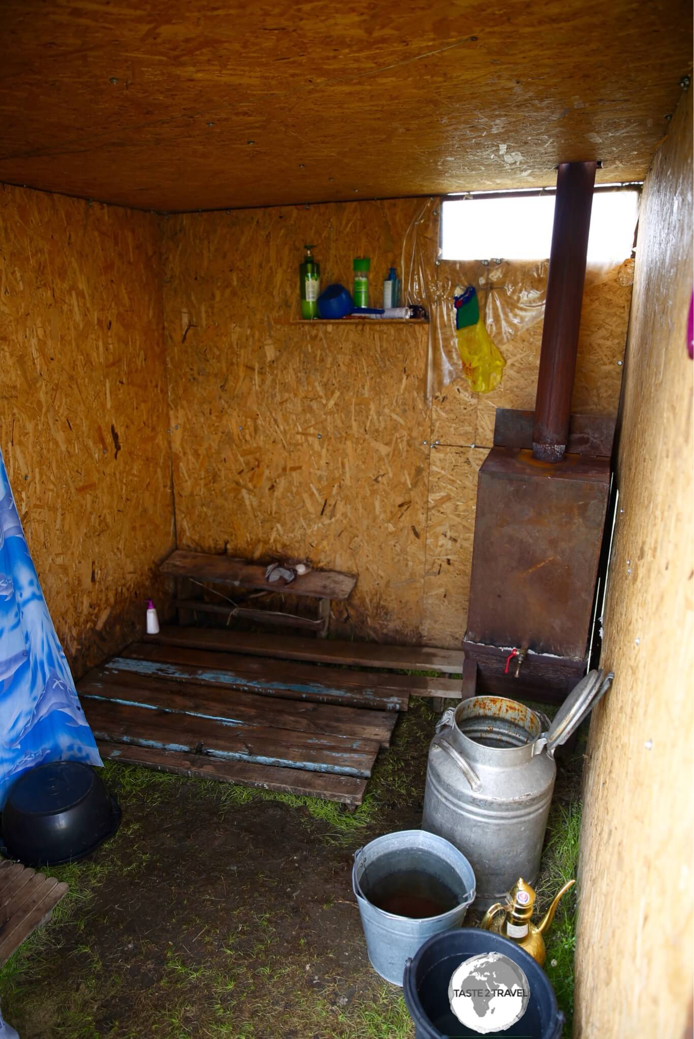 The improvised shower block at the yurt camp on Lake Son-Kul, where ice-cold mountain water is heated using a manure-fired stove.