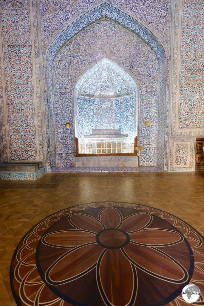 The tomb of Pahlavan Mahmud surrounded by the intricate wooden parquet floor of the mausoleum.