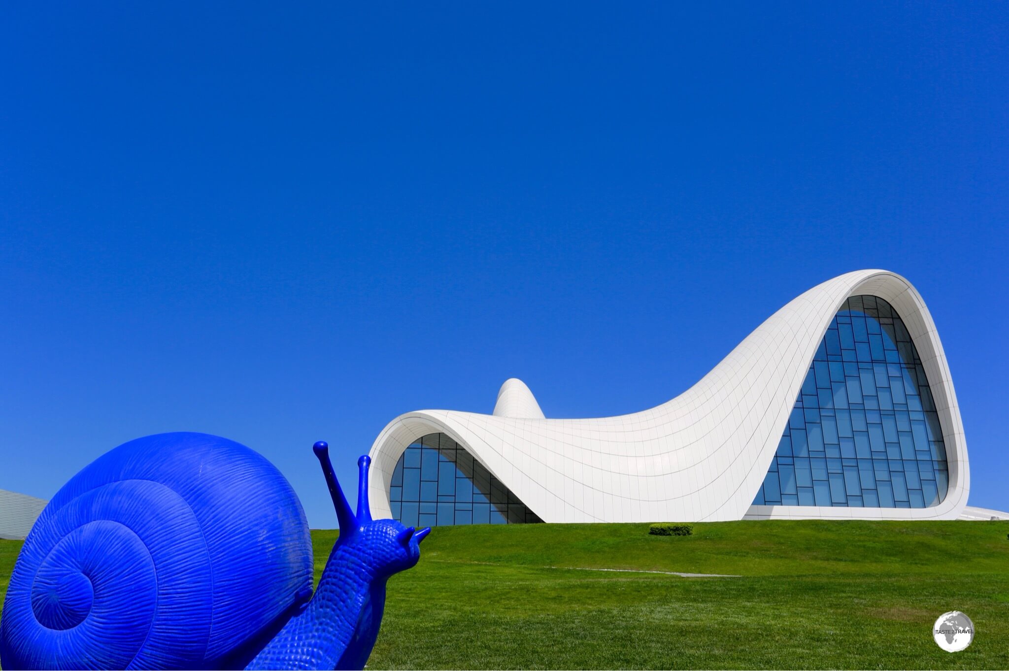 Azerbaijan Travel Guide: Funky artwork and the amazing Zaha Hadid-designed Heydar Aliyev Centre in Baku. 