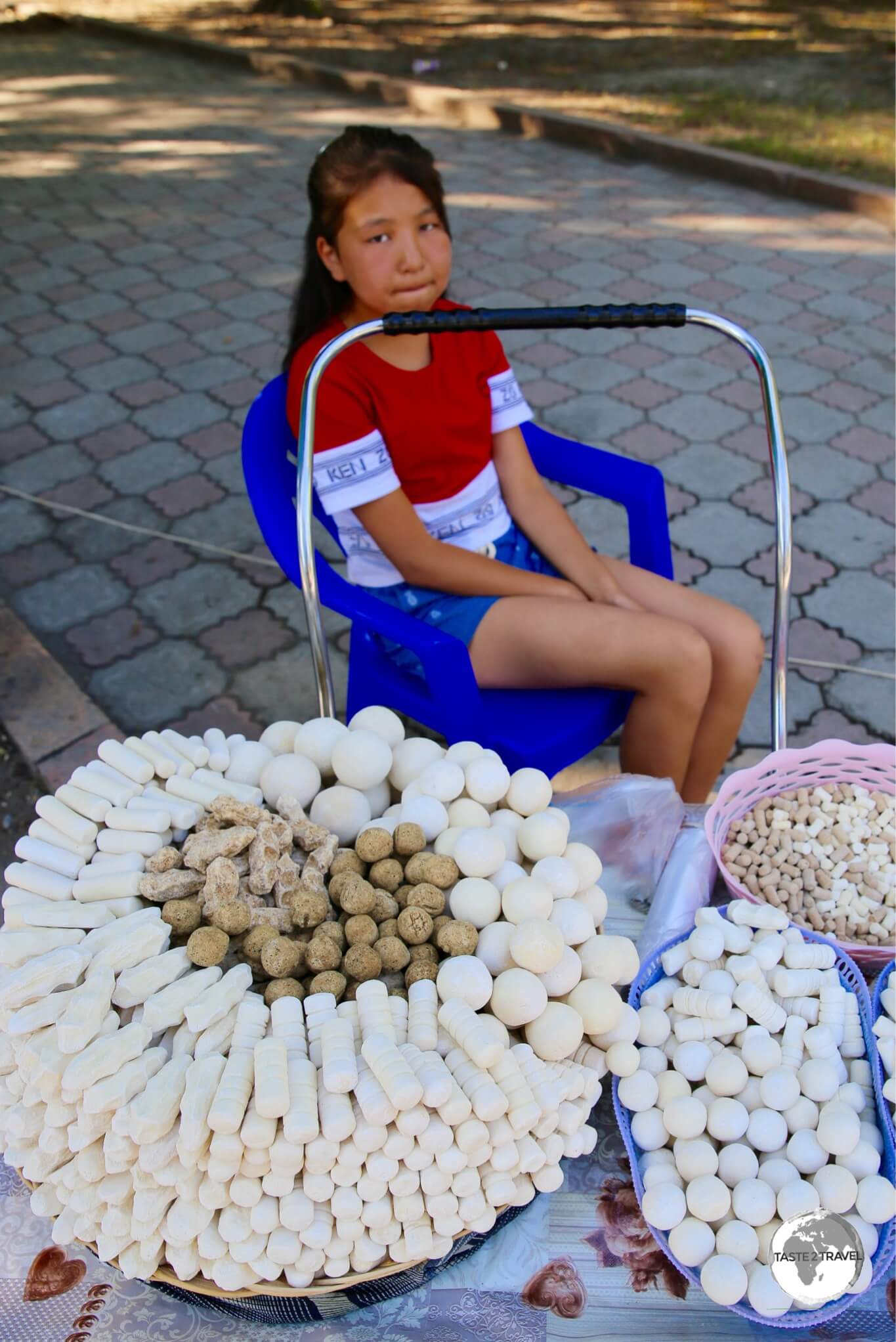 Selling <i>Kashk or Qurt</i> - a hard, salty fermented cheese snack - in downtown Bishkek.