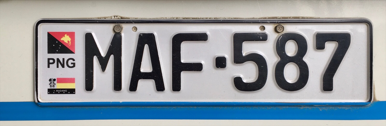 A PNG number plate with the 'M' indicating this vehicle is registered in Madang province.