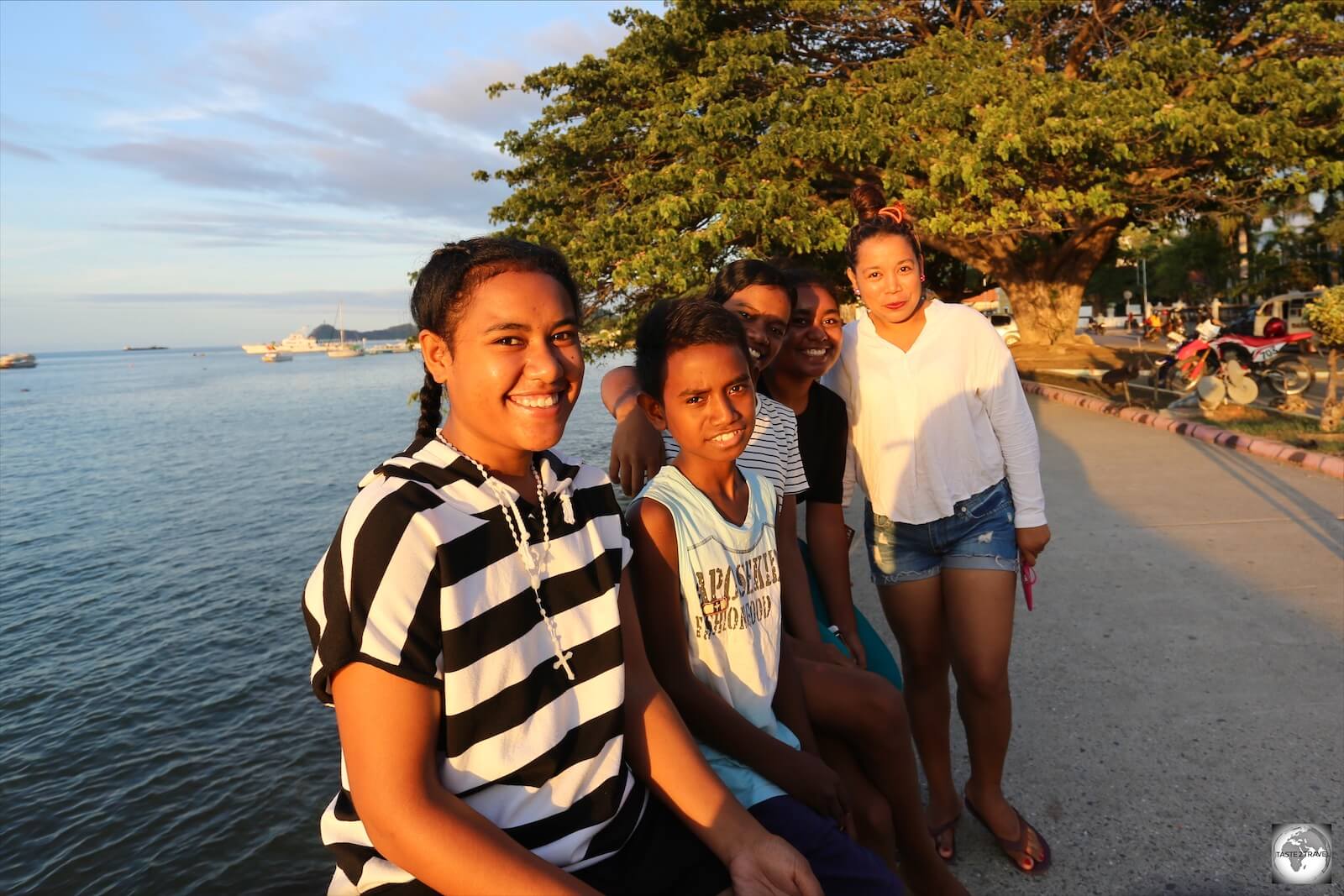 A Timorese family enjoying sunset on the waterfront in Dili. 