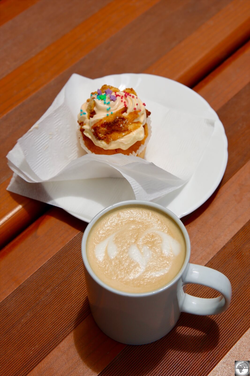 A Flat white coffee and a freshly made cupcake at the Tropicana café.