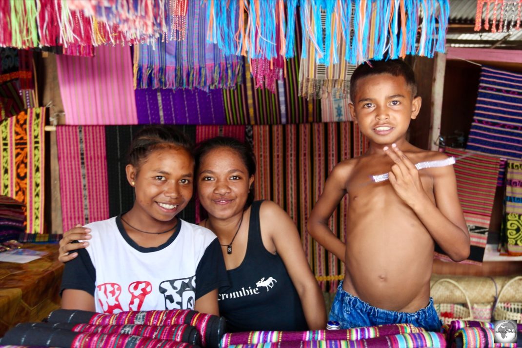 Friendly Timorese youth selling traditional Tais cloth in the Tais market in central Dili.