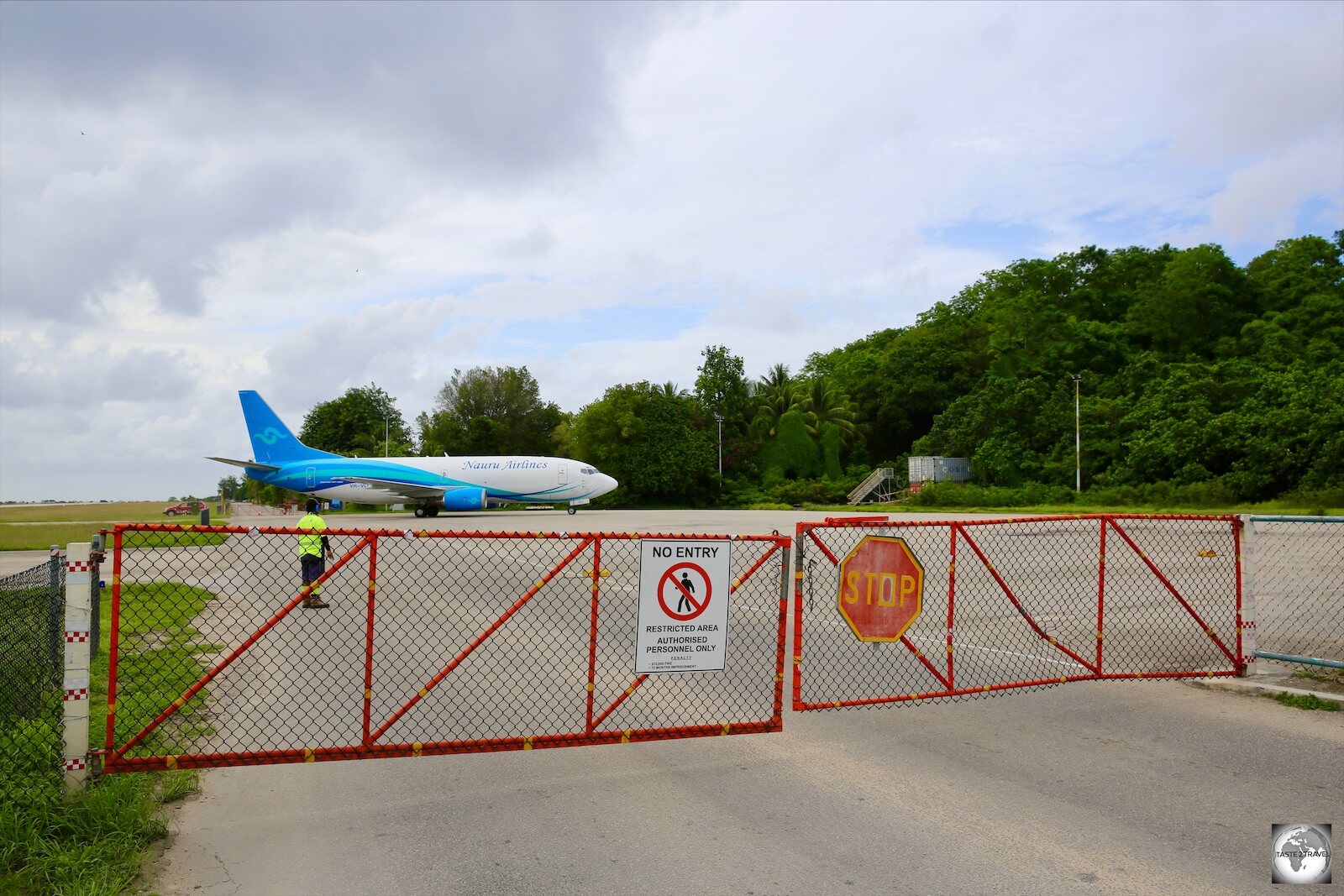 When planes are present at Nauru airport, this portion of the Island Ring road, which doubles as the taxiway and apron at the airport, is closed to traffic. 