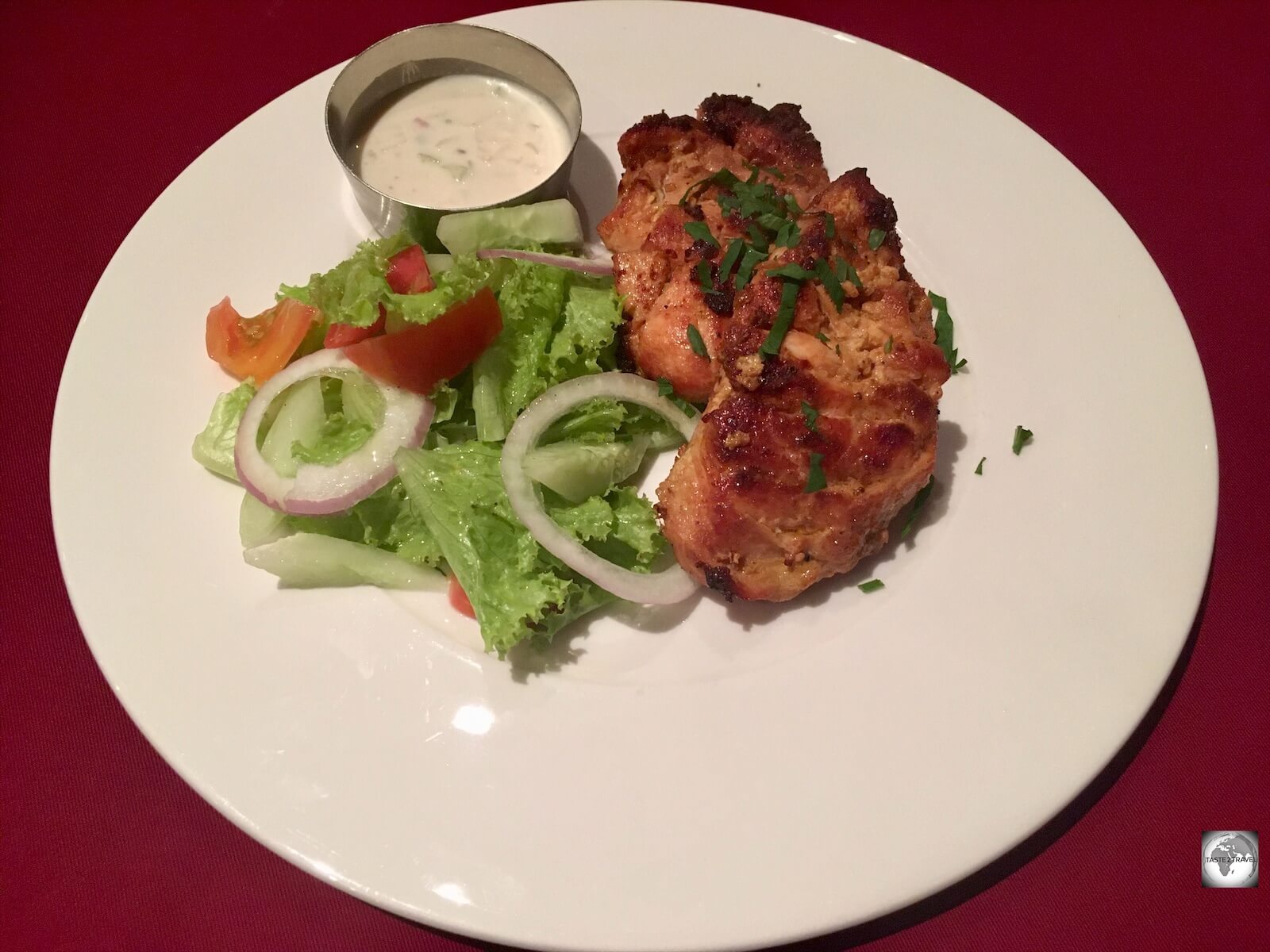 Chicken tandoori, served with salad and Raita at the Diya Restaurant in Dili. 