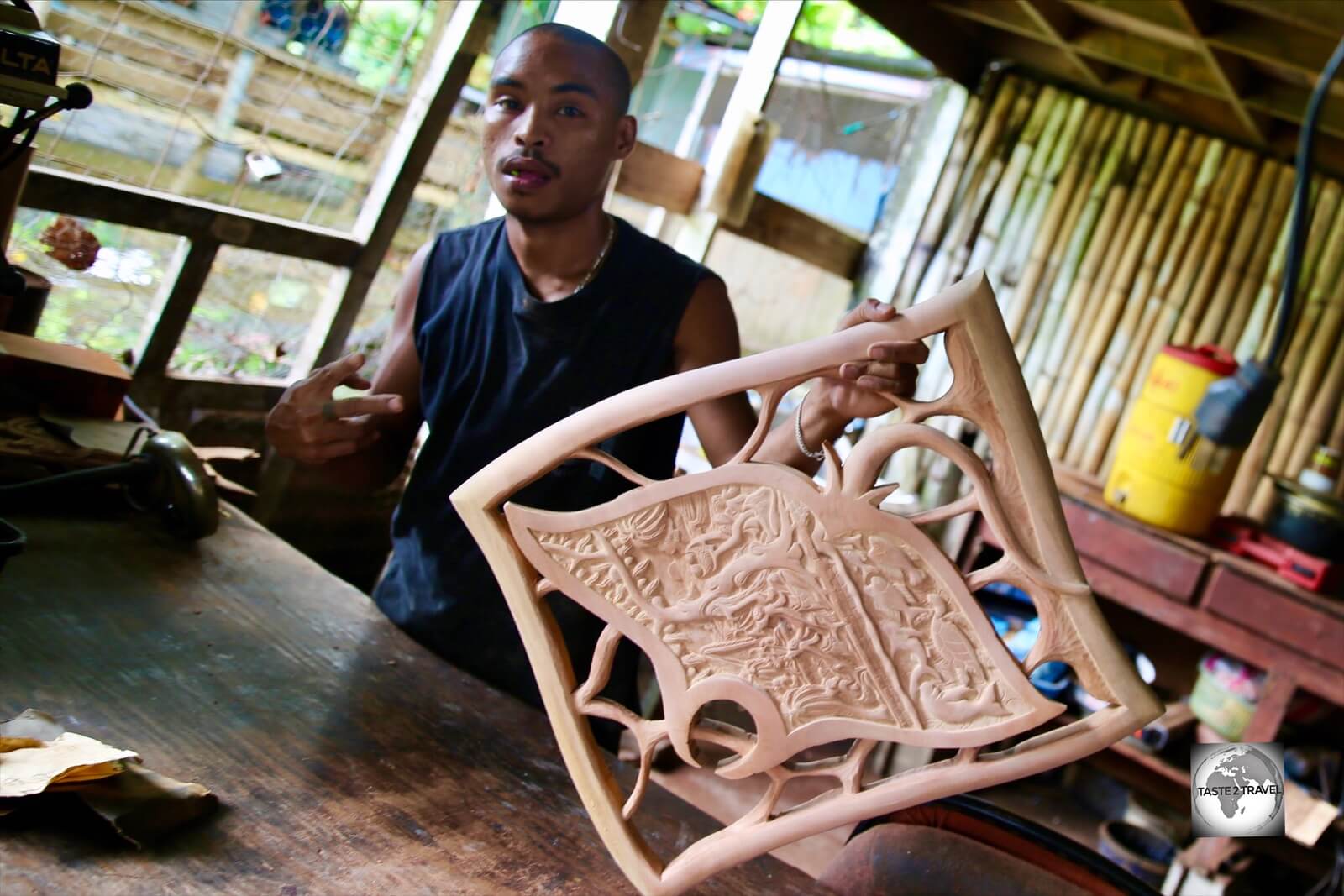 A 'story board' wood carver at his workshop in Koror.