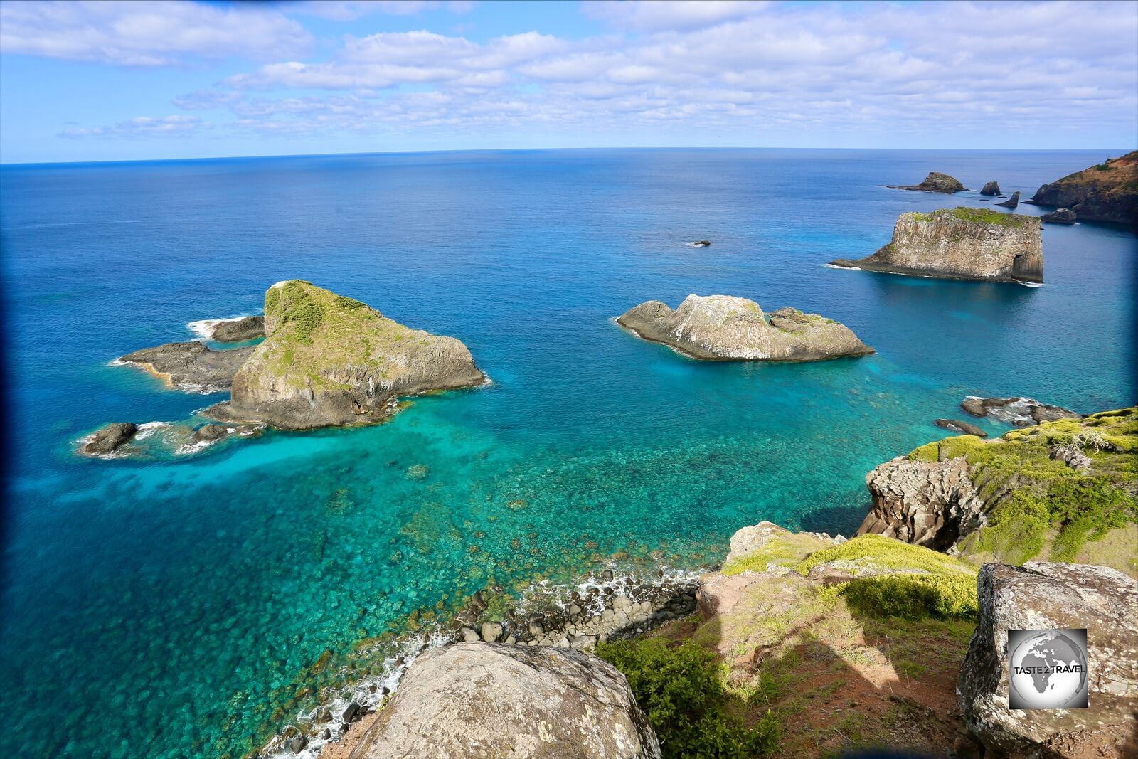 A view of the north coast of Norfolk Island from Captain Cook's lookout with the islands of (l-r) Bird Rock, Green Pool and Cathedral Rock.