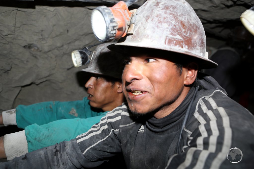 Deep inside Cerro Rico, miners, chewing coco leaves, push past our tour group with a fully loaded wagon of ore. It's claimed that the coca leaves help filter dust.