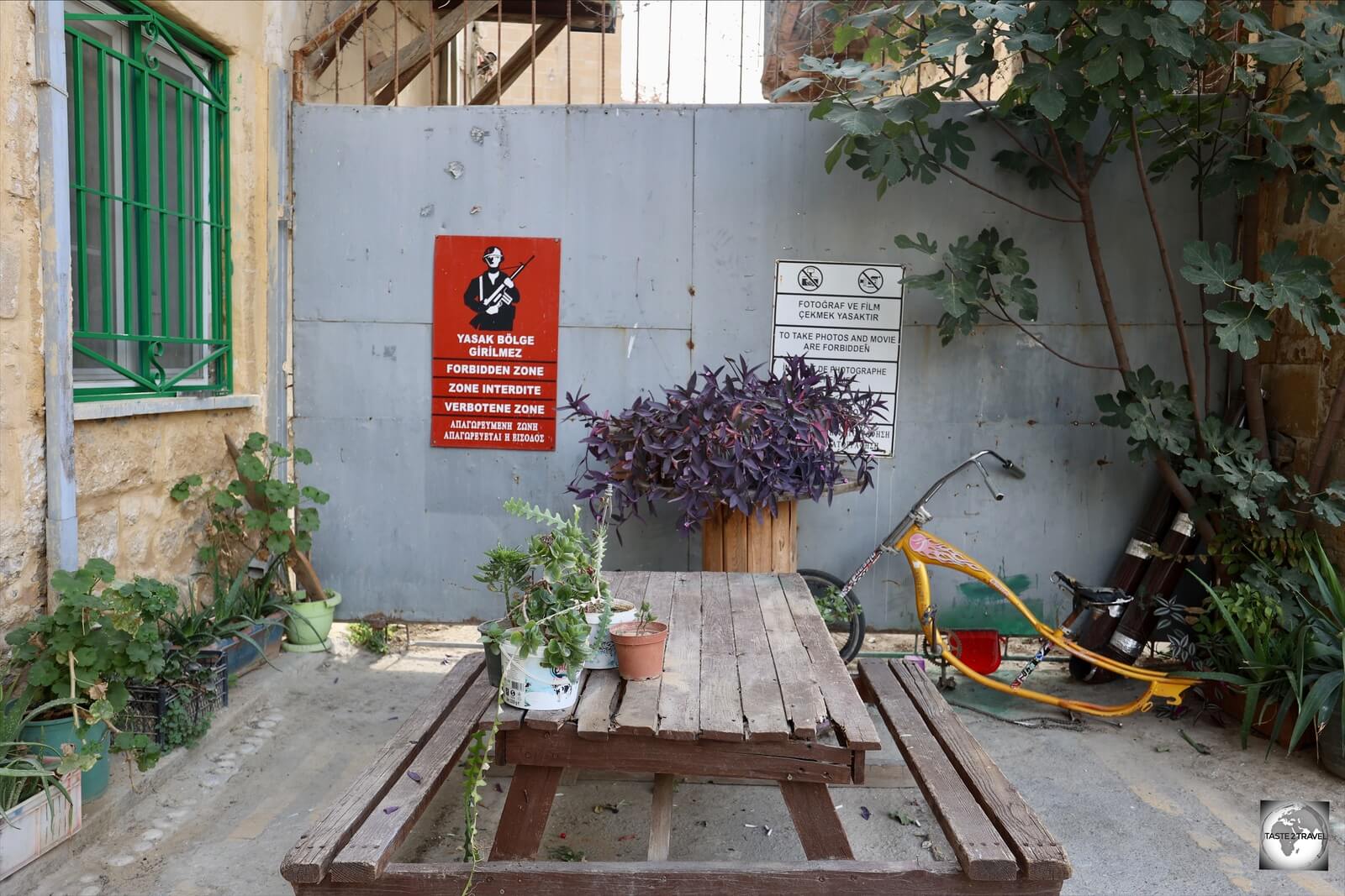 Garden furniture outside a residential building in North Nicosia softens the effect of the steel wall of the UN Buffer zone.