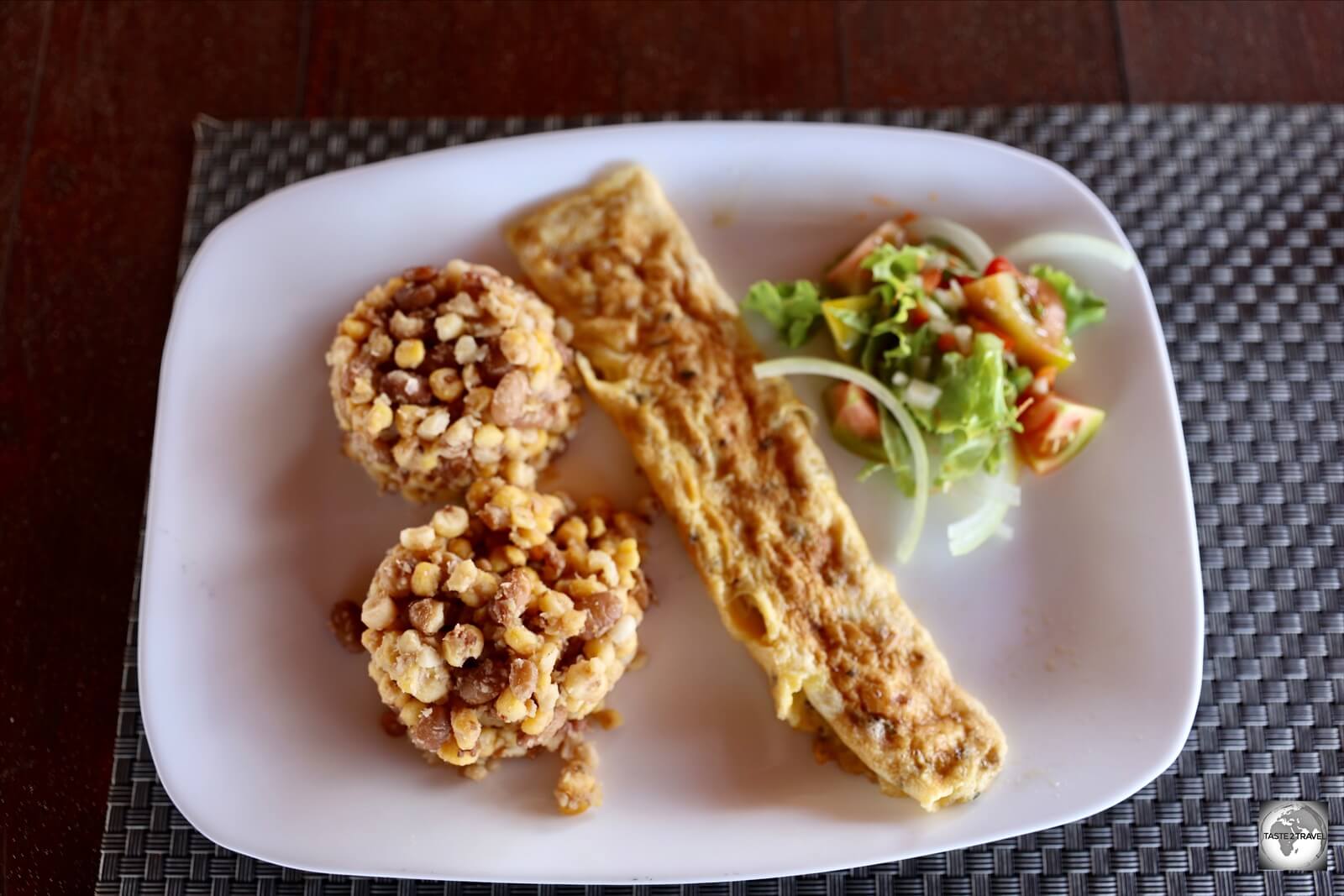 A dry version of Cachupa (left) with omelette and salad, served at the Viana Club on Boa Vista.