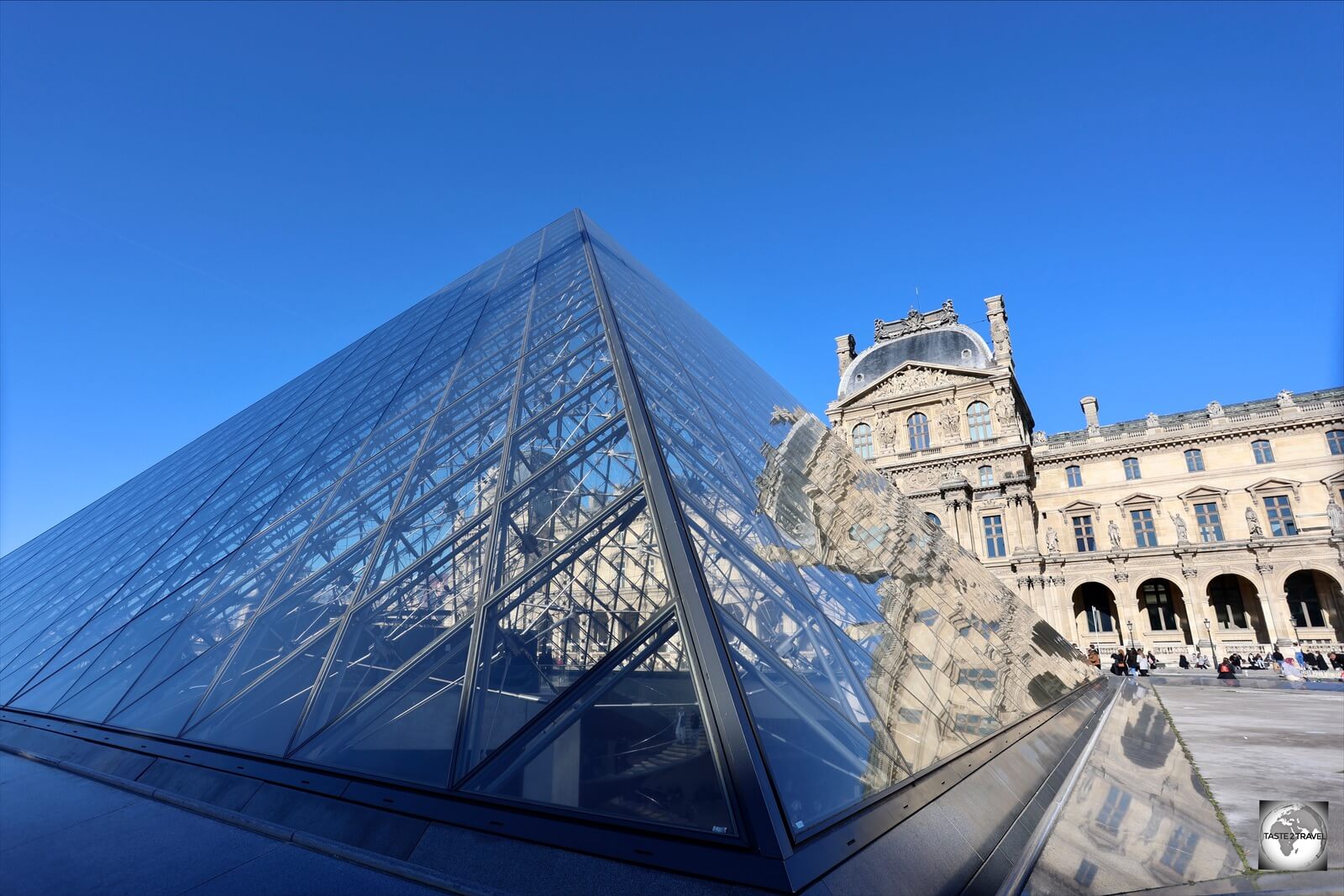 A photo of the glass pyramid at the Louvre Museum which was installed by the architect I. M. Pei.