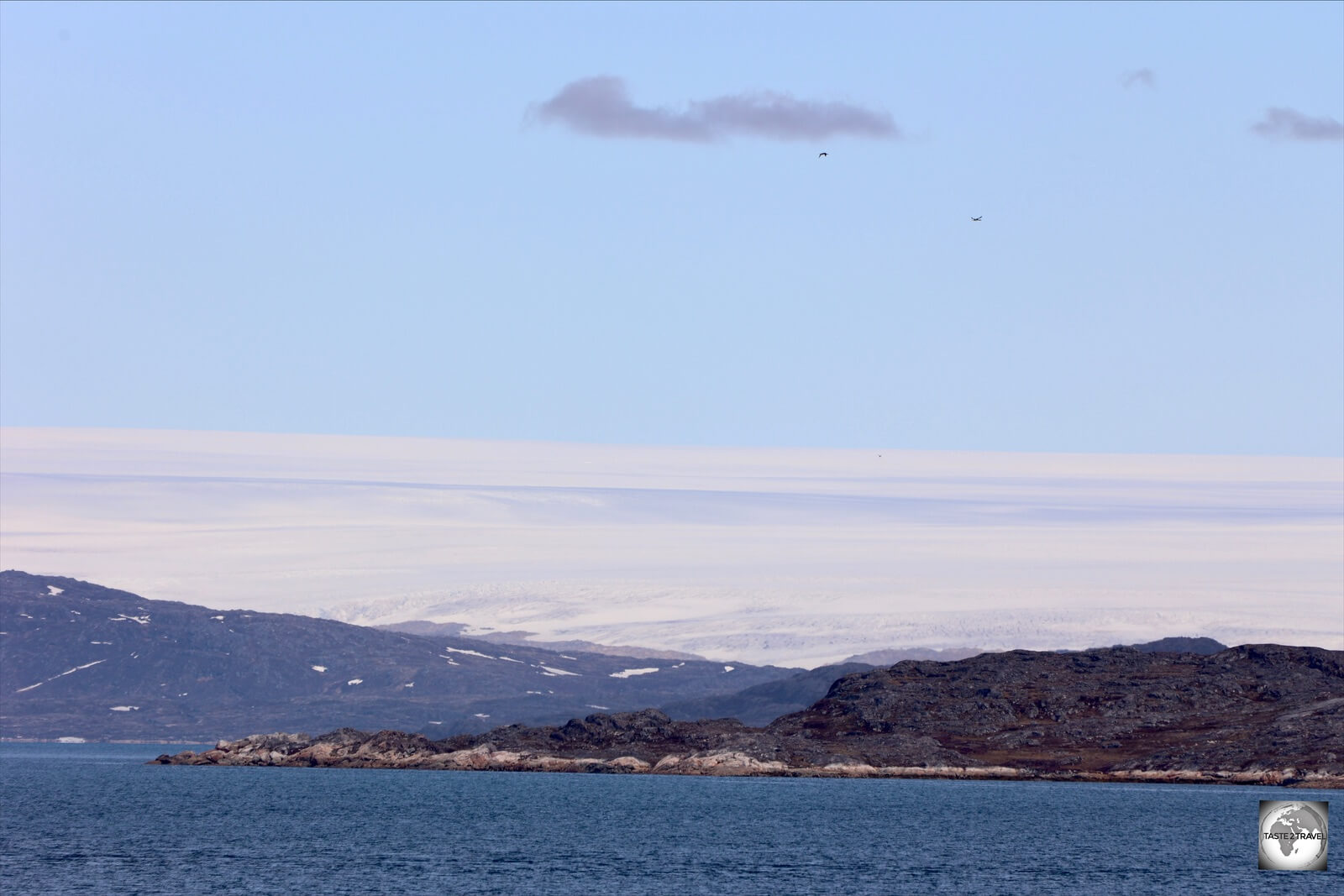 As seen from the Sarfaq Ittuk, the 1,500-metre-deep Greenland Ice Sheet covers the entire landscape, like icing on a wedding cake.