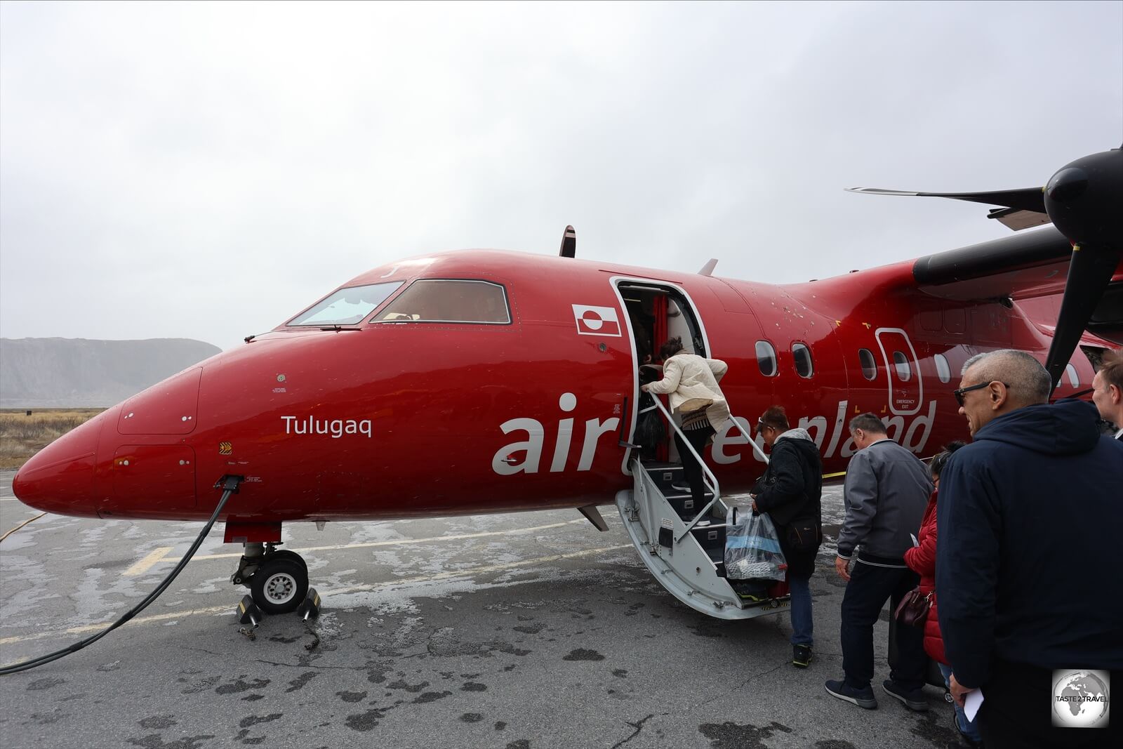 Boarding an Air Greenland Dash 8-200 plane at Kangerlussuaq Airport.