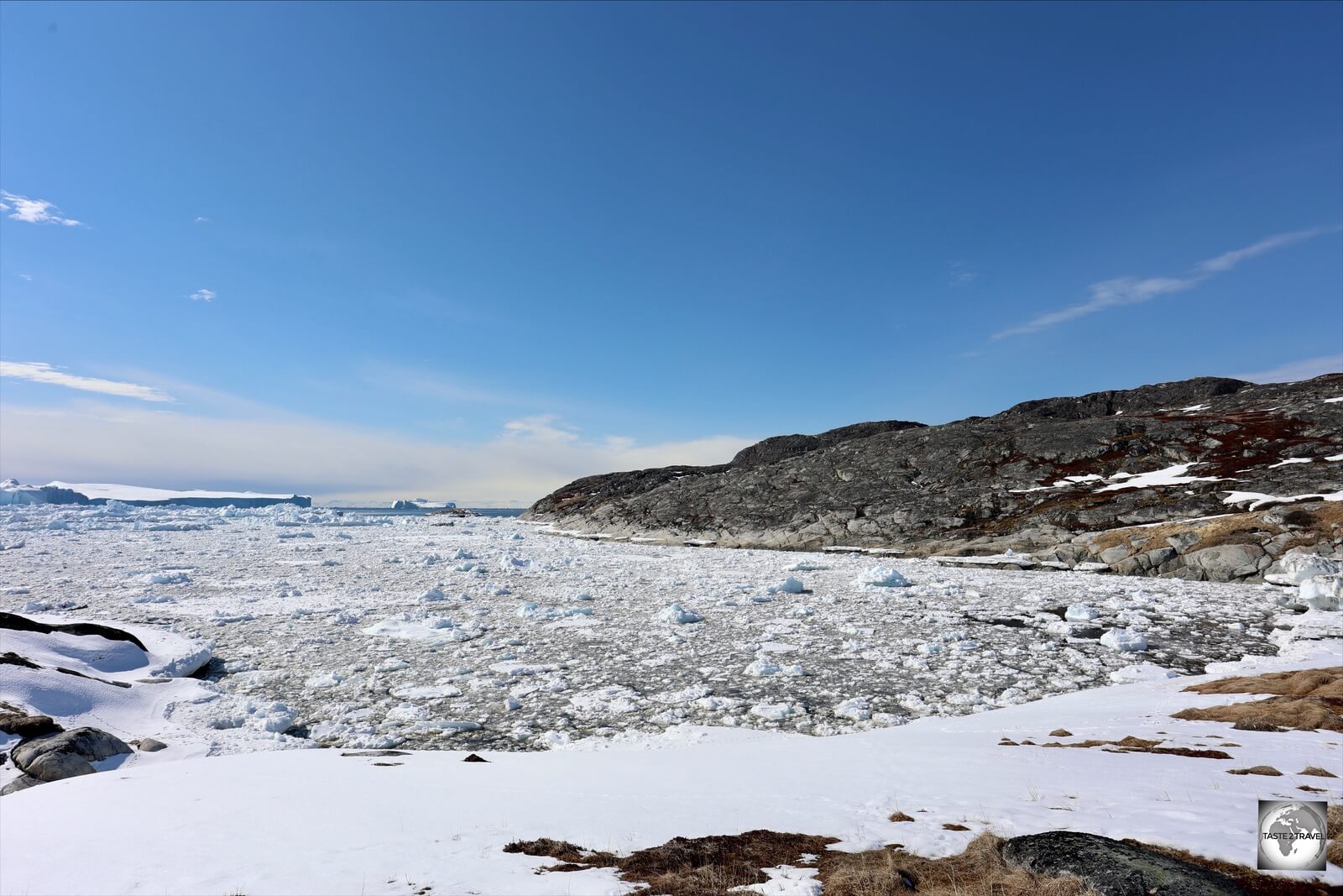 A view of the Ilulissat Icefjord from a hiking trail. Warning signs in this bay warn against tsunami waves caused by calving icebergs.