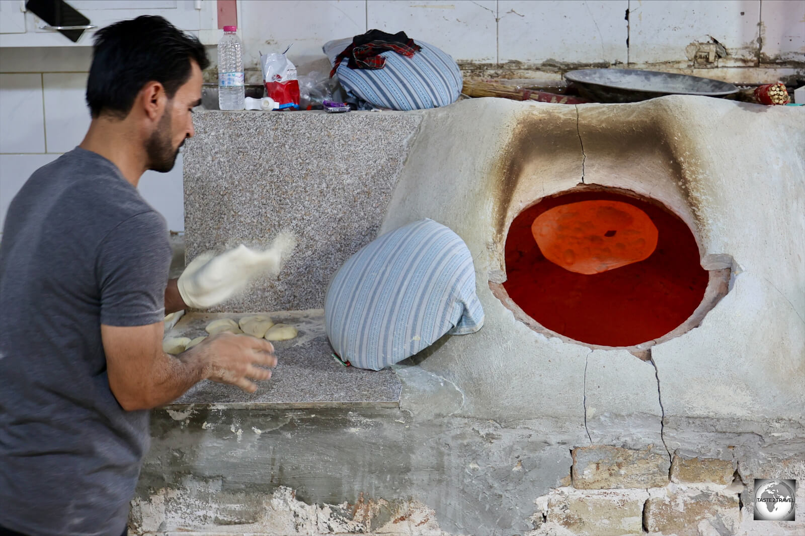 Baking Khubz (flatbread) in a traditional tannour (Tandoor oven) in Sulaimaniyah.