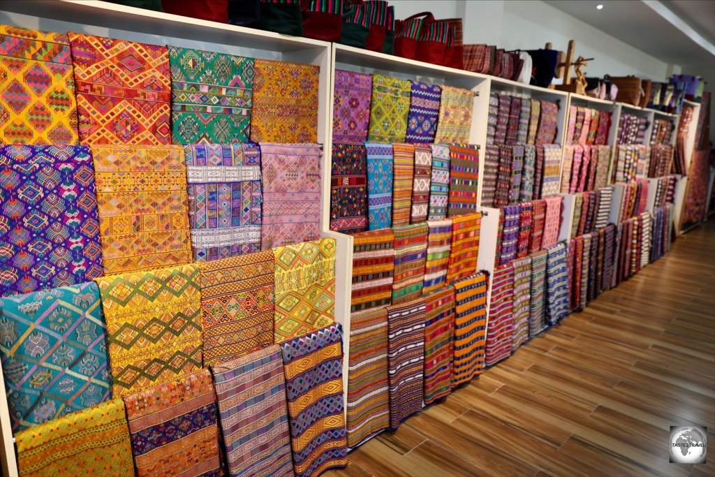 A range of handwoven fabrics in the gift shop at the A weaver at the Gagyel Lhundrup Weaving Centre in Thimphu.