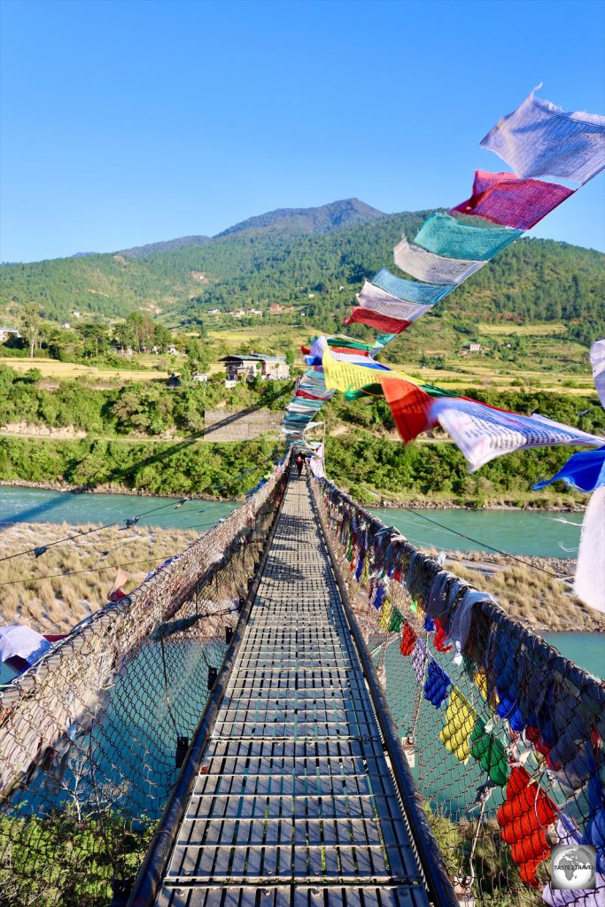 Prayer flags flutter on Punakha suspension bridge - the longest in Bhutan.