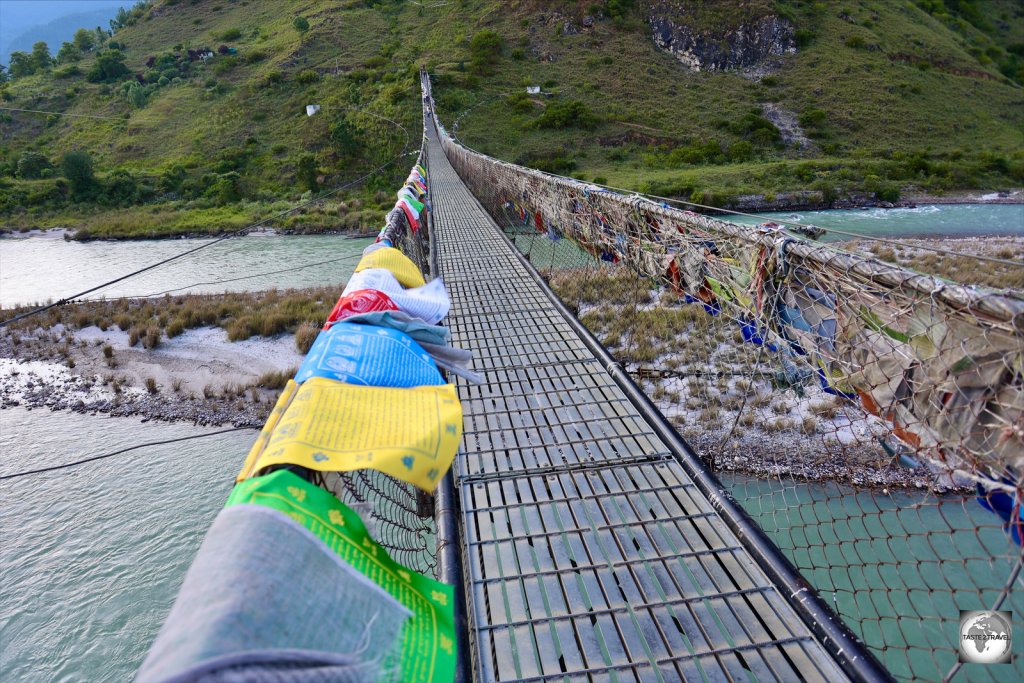 Prayer flags flutter on Punakha suspension bridge - the longest in Bhutan.