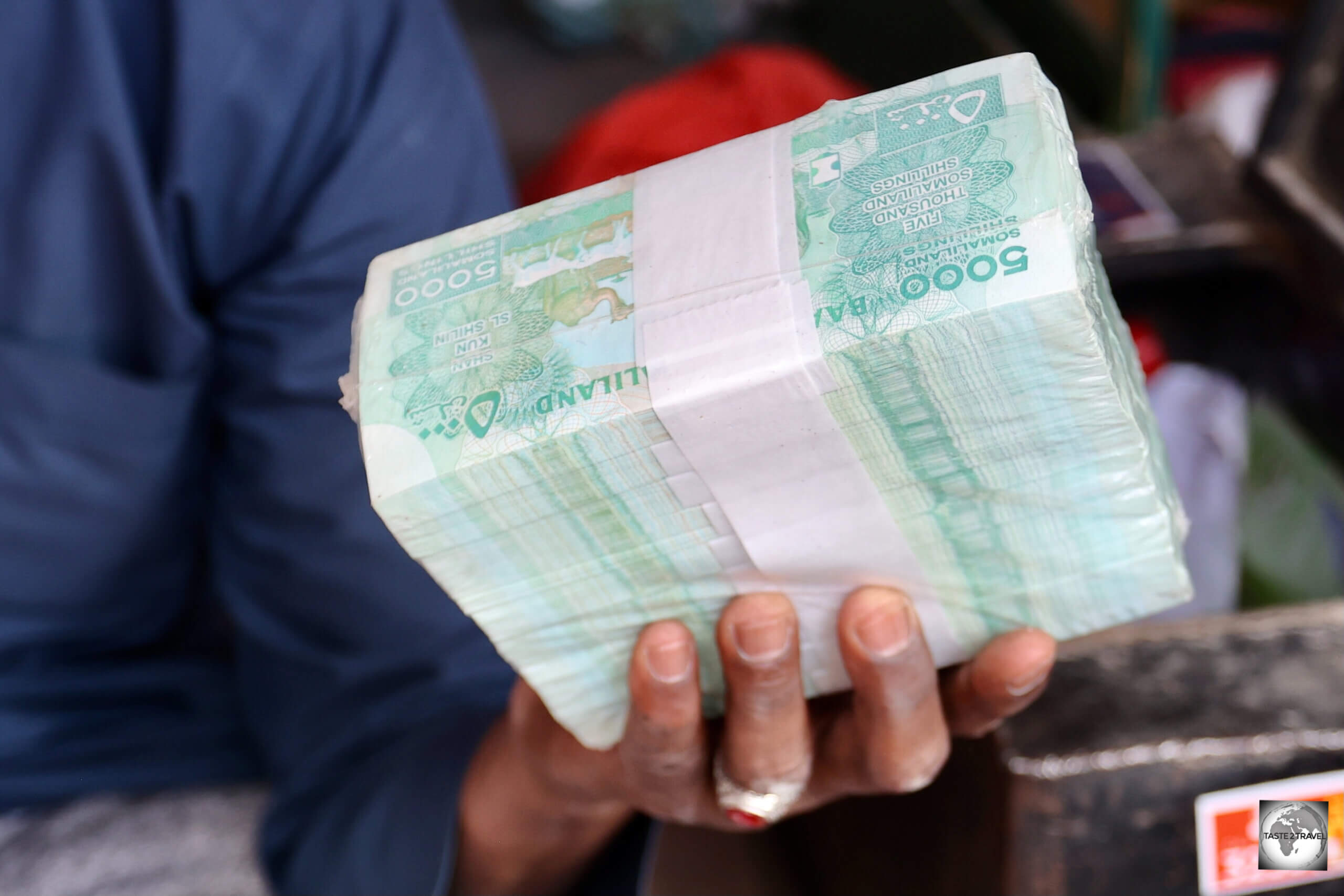 Straight from the Central Bank - an impressive wad of one thousand, uncirculated, 5,000 shilling bank notes - worth US$588.