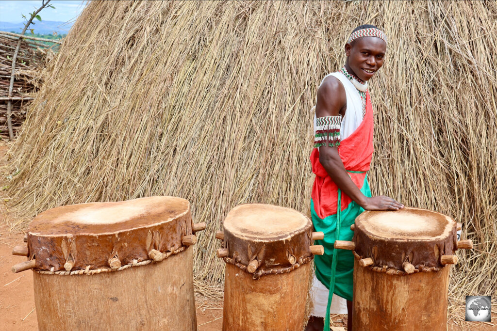 A Gishora Royal Drummer and a selection of drums alongside the Royal Palace.