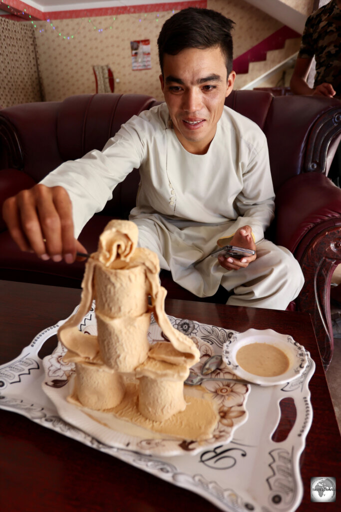 My driver, Hamid, preparing to enjoy a monumental platter of Sheer Yakh in Balkh.