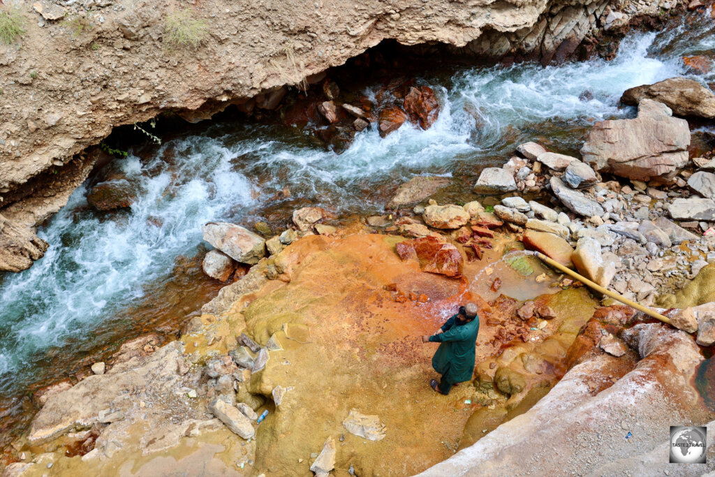 Mineral rich, fresh mountain water, has stained the rocks in this roadside gorge.