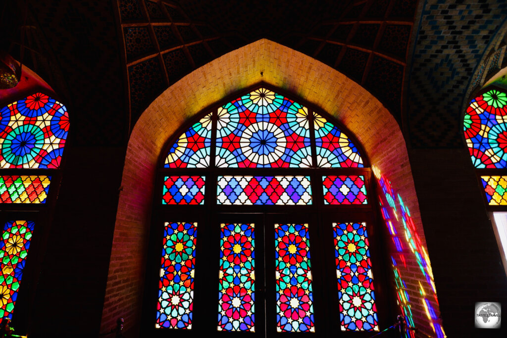 The best time to photograph the windows at the Nasir al-Mulk Mosque is in the early morning, during the winter season.