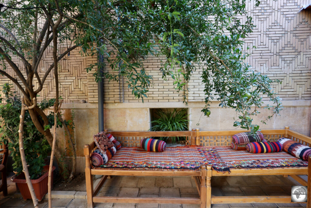 The leafy courtyard of the Taha Traditional Hostel in Shiraz.
