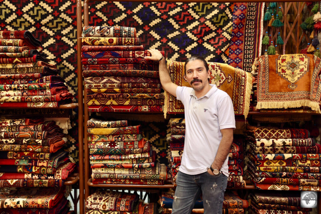 A carpet seller at one of the many carpet shops which line Naqsh-e Jahan Square, Esfahan.