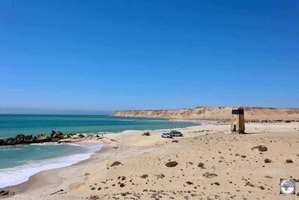 A panoramic view of Porto Rico Beach, with its abandoned Spanish-era lighthouse.