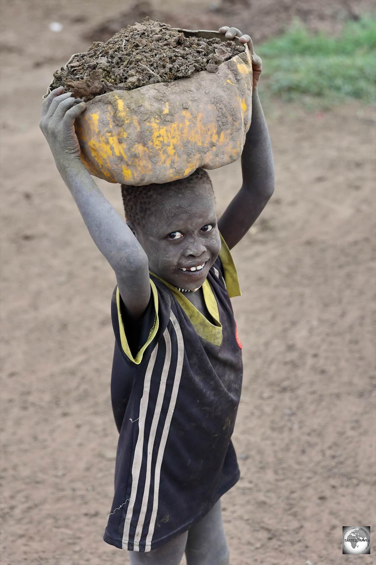 The collecting of cow dung keeps most of the Mundari children busy. 