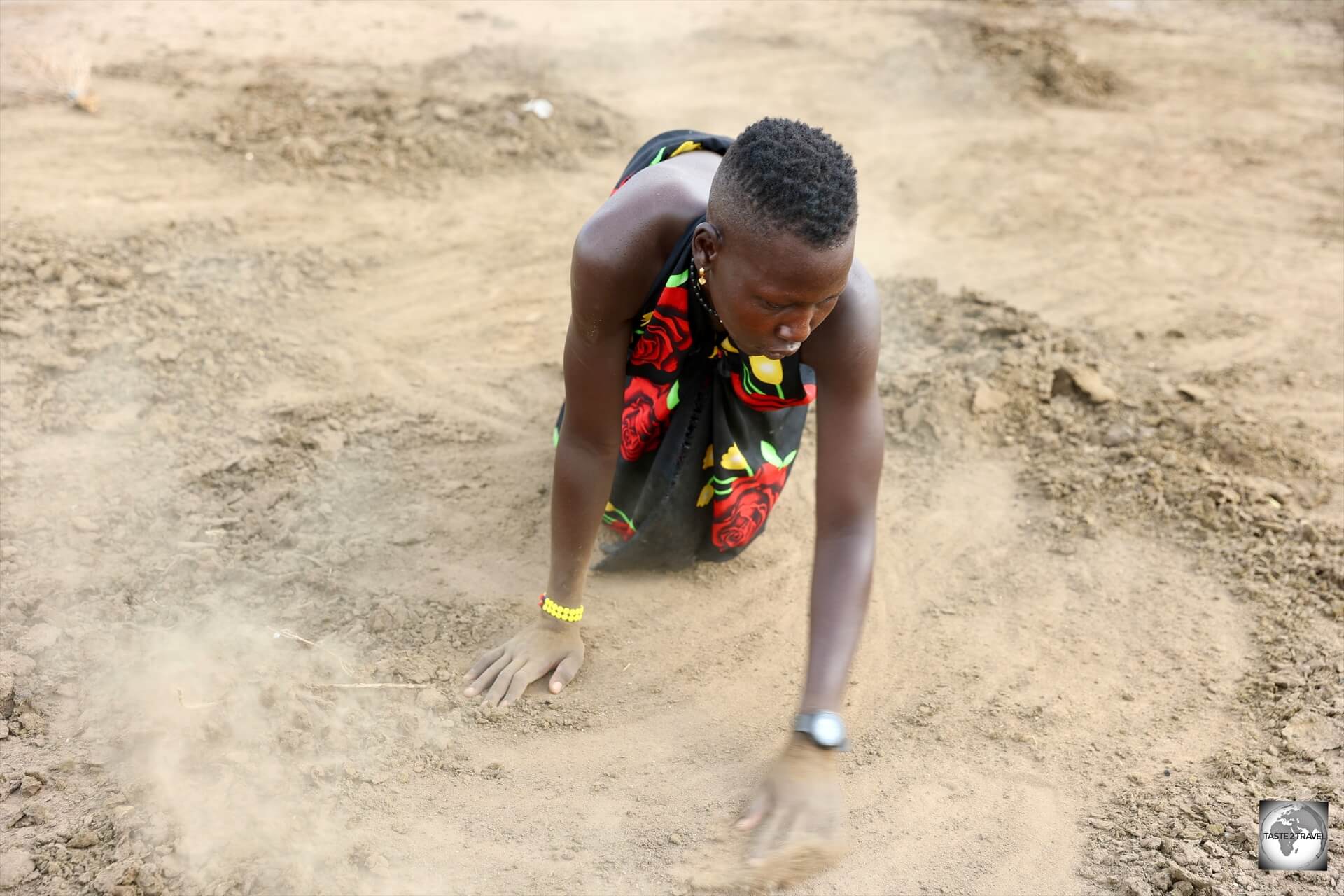 A Mundari girl, gathering cow dung which will be burnt on one of the many camp fires. A Mundari girl, gathering cow dung which will be burnt on one of the many camp fires. 