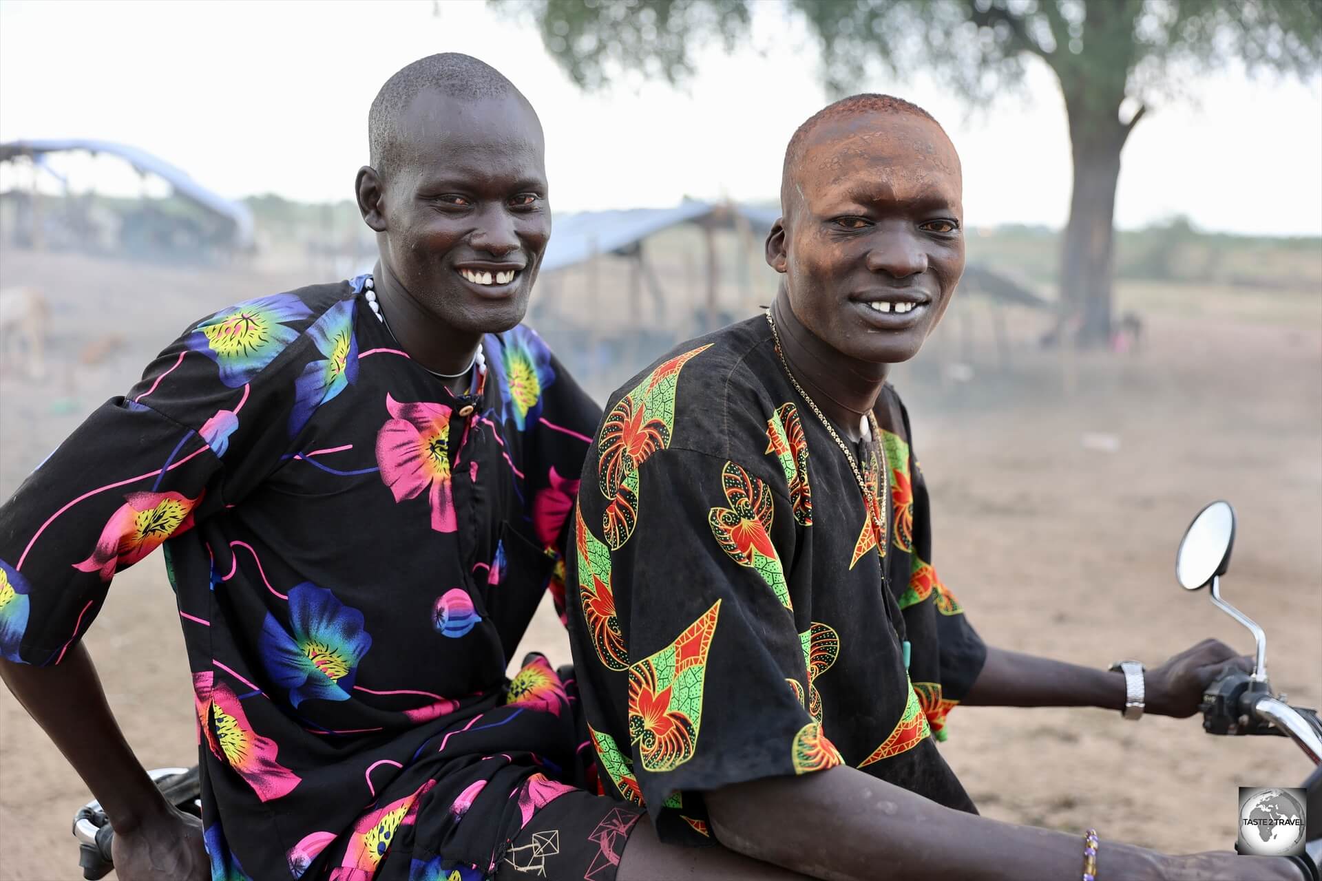 Two Mundari cattle herders on a motorbike. 