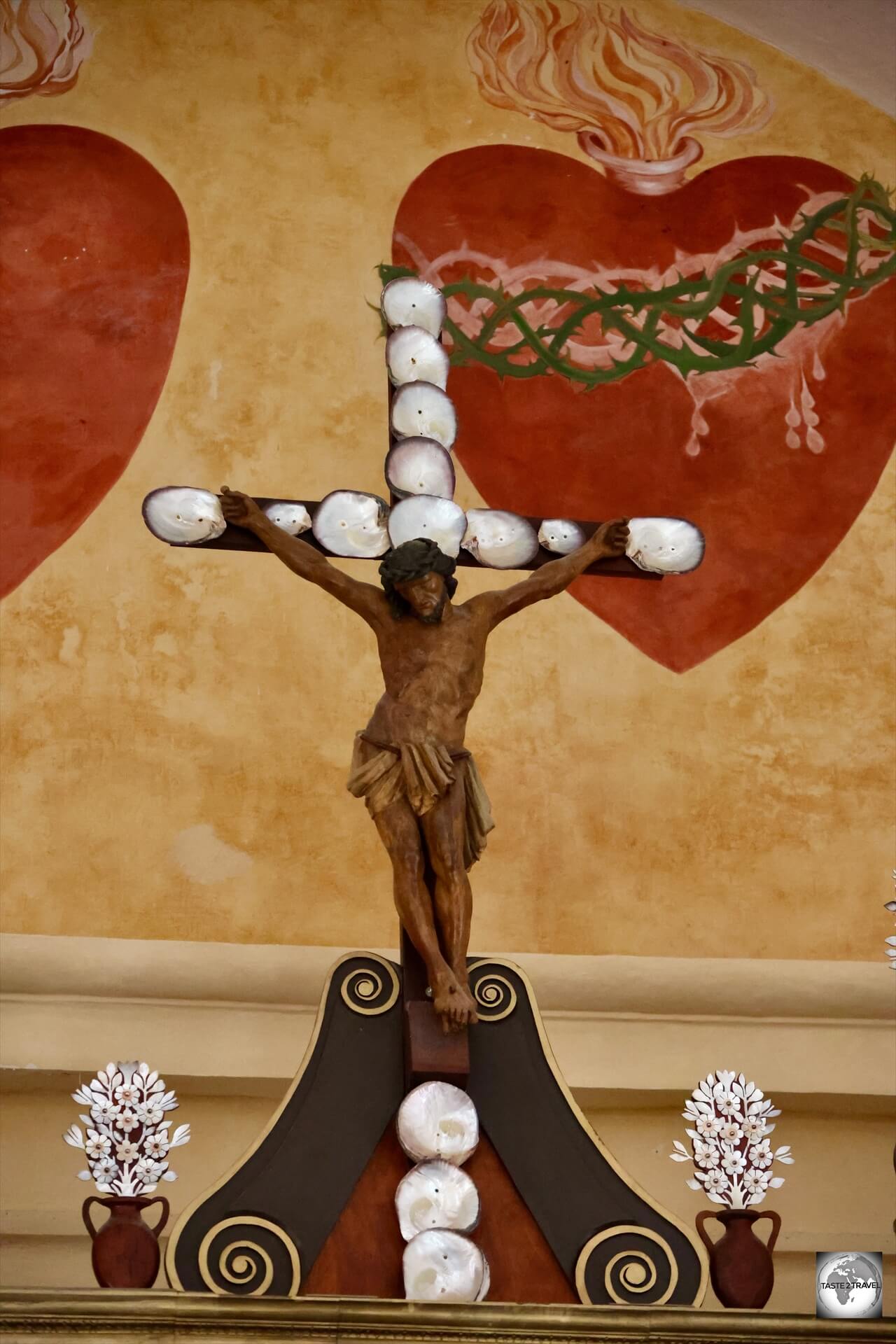 The cross which adorns the altar of St. Michael's Cathedral is covered in oyster shells.