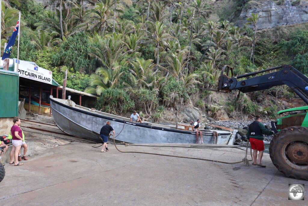 The heavy "Moss" longboat is launched from the boat shed by attaching a rope to a tractor which then pulls it down the boat ramp.