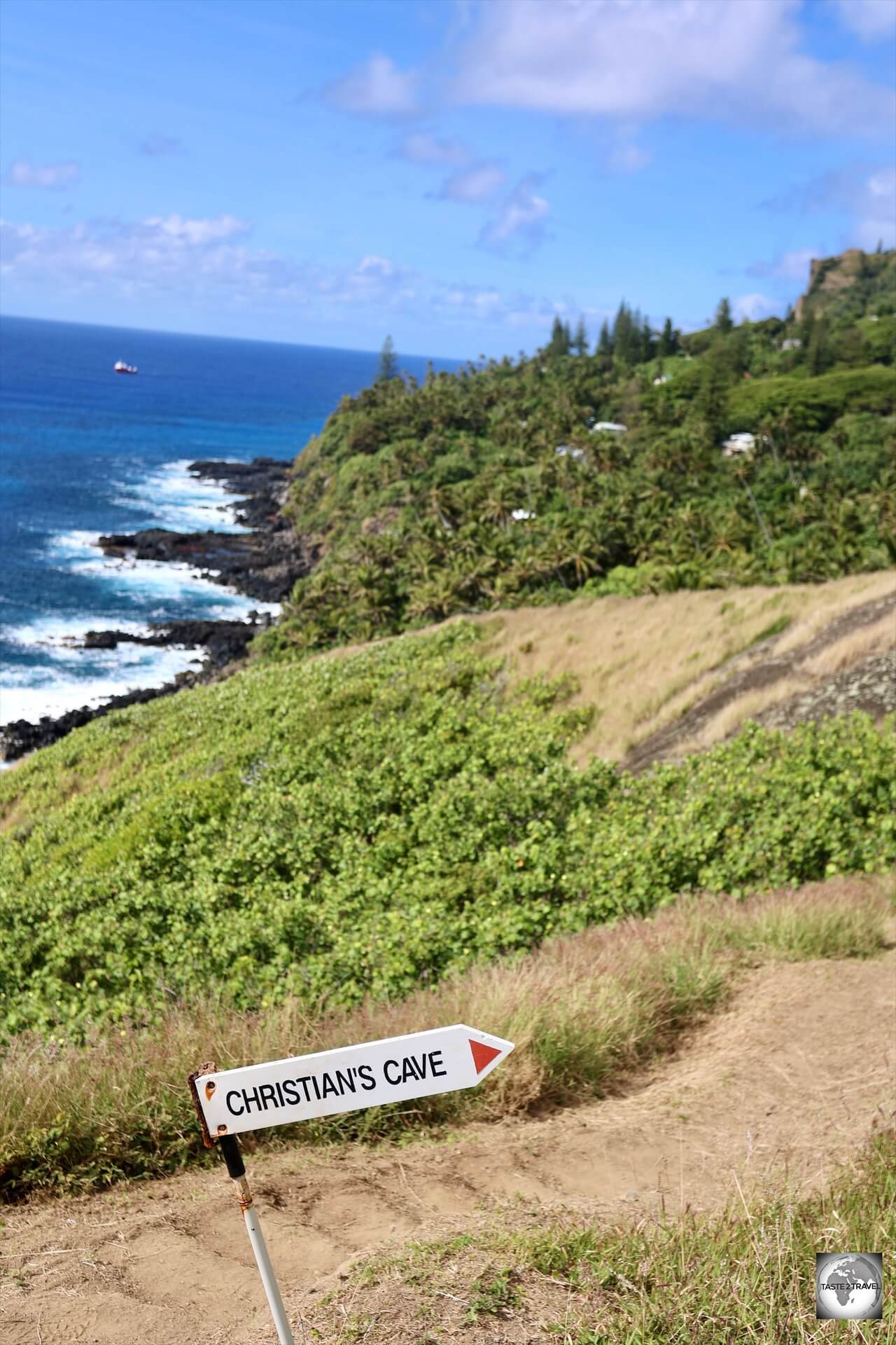 A sign points the way to Christian's cave on Pitcairn Island.