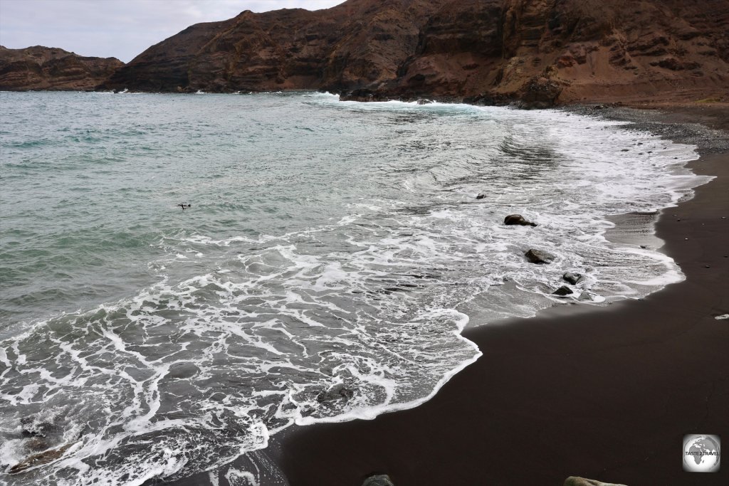 The only real beach on Saint Helena, the jet-black sand beach at Sandy Bay.