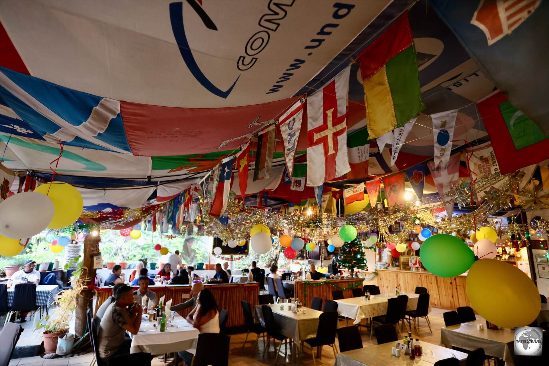 The ceiling at Anne's Place is decorated with flags which have been donated by the many passing yachts.