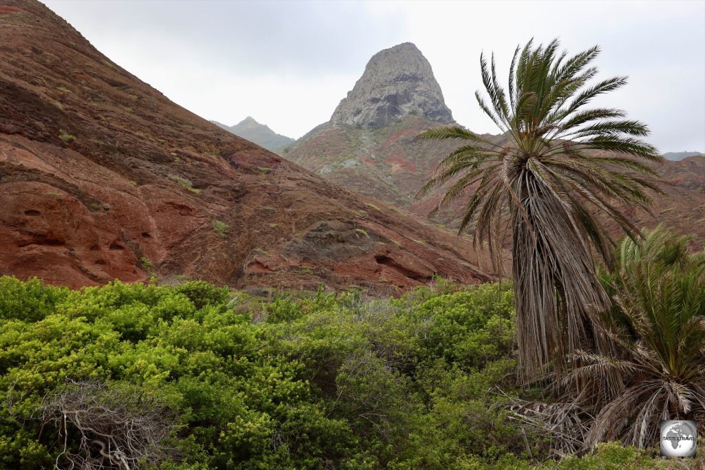 The volcanic plug, known as 'Lot', towers over the arid landscape of Sandy Bay.